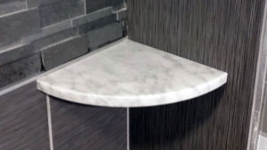 white marble shower shelf