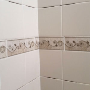installing shower shelf on already tiled wall